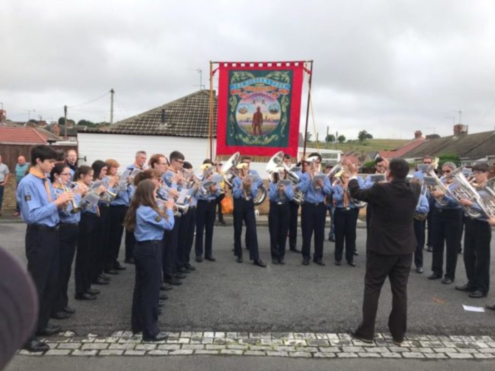 Brass band play in front of Horden Banner